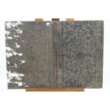 A pair of embossed panels laid onto wood and painted black,