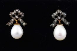 A yellow and white metal pair of drop earrings each having a freshwater pearl