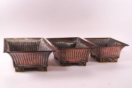 A set of three plated planters of graduated lozenge form with ribbed bodies