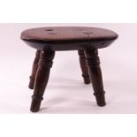 An elm stool on turned legs,