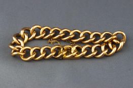 A yellow metal curb link bracelet with push in clasp and safety chain.