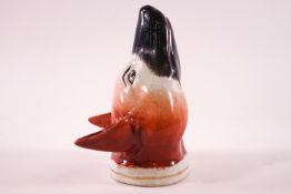A 19th century Staffordshire pottery stirrup cup in the form of a fox's head,