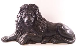 A Victorian cast iron figure of a recumbent lion,