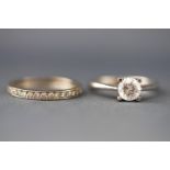 A selection of two white metal rings,