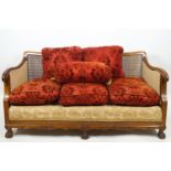 A carved walnut Queen Anne style bergere three piece suite with shell carved cresting rail