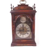 A red Japanned 18th century style bracket fusee clock with domed top set a strap handle and four