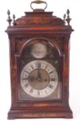 A red Japanned 18th century style bracket fusee clock with domed top set a strap handle and four