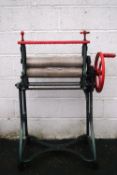 A Ewbank cast iron and painted mangle, on wheels,