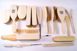 A mixed collection of 19th century and early 20th century ivory backed brushes together with ....