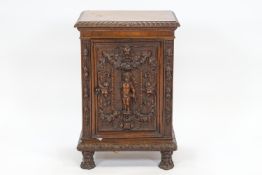 A 19th century profusely carved walnut side cupboard, the rectangular top with a gadrooned edge,