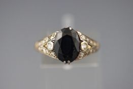 A yellow and white metal ring set with an oval faceted cut sapphire together with ....