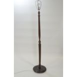 A hardwood standard lamp of ribbed baluster from,