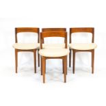 A teak dining set, comprising a round table,