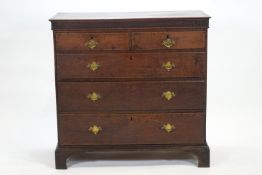 An oak chest of two short and three long drawers,