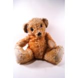 A large Merrythought plush hygienic toy teddy bear, in the seated position with button to left ear,