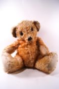 A large Merrythought plush hygienic toy teddy bear, in the seated position with button to left ear,