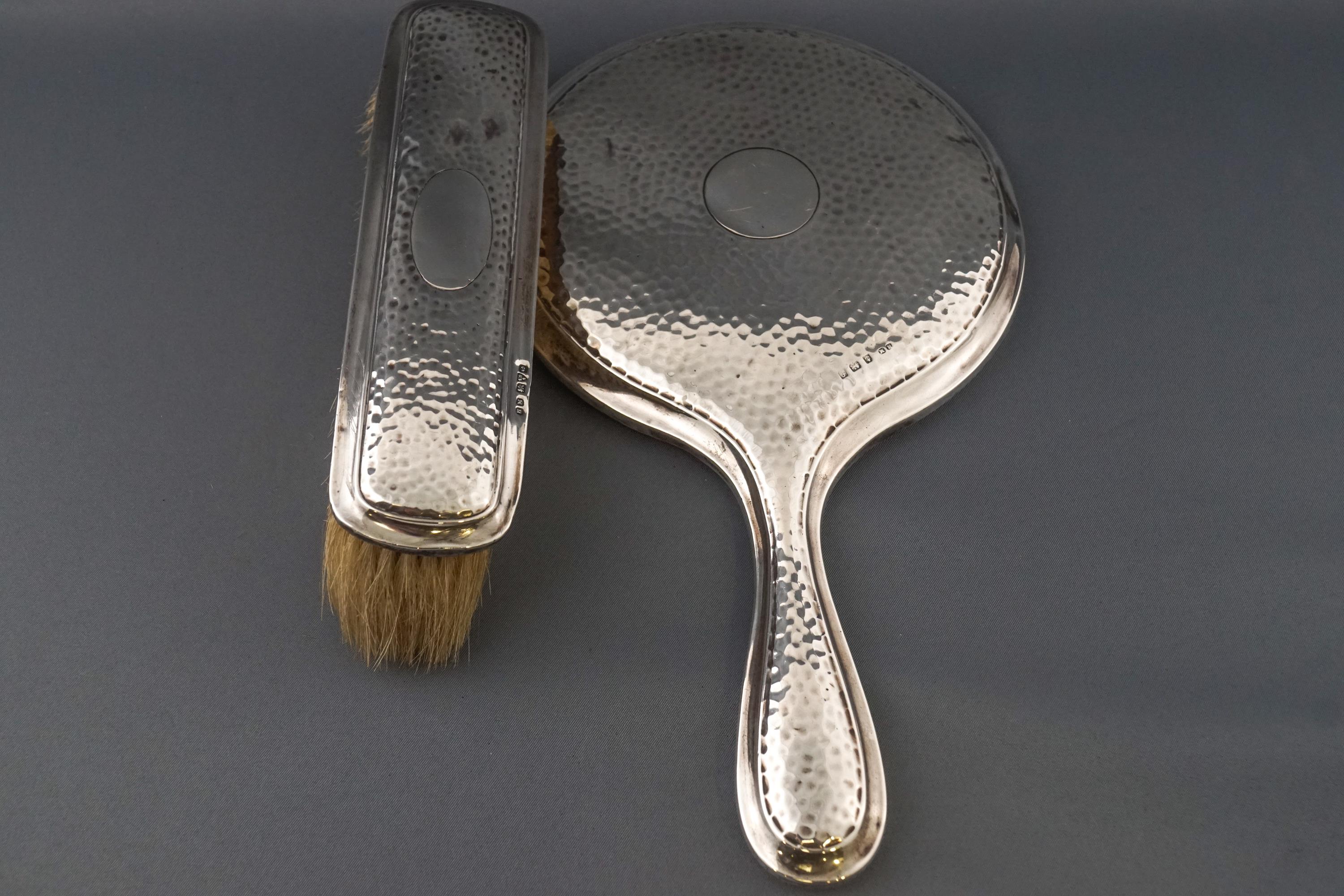 A part dressing set, consisting of a hand mirror and a clothes brush,