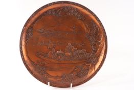 An early 20th Century Japanese wall plate with copper effect patina, seal mark to the reverse,