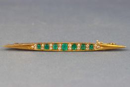 A yellow metal bar brooch.