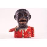A cast iron money box in the form of a Negro,