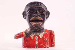 A cast iron money box in the form of a Negro,