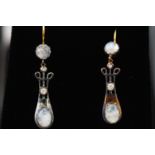A pair of drop earrings set with cabochon moonstone and diamonds. Hook fitting.
