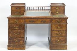 An oak Dickens style desk, the rectangular top with two end towers,
