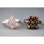 A selection of two dress rings, one as a marquise cluster set with tanzanites....