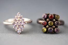 A selection of two dress rings, one as a marquise cluster set with tanzanites....