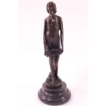 A bronze figure of a Diaphanously clothed singing lady, raised on a turned stone base,