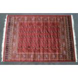 A machine woven Keshan style carpet with eleven rows of medallions on a red ground