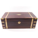 A Victorian brass bound writing slope with secret drawer, the rosewood body with central escutcheon,