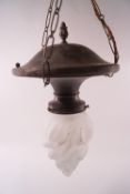 A brass hanging lamp with glass flame shaped shade,