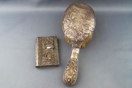 A handled hairbrush, profusely decorated with a hunting scene of the kill, Birmingham 1903,