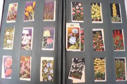 An album of assorted cigarette cards by Wills, Player etc, including flowers,