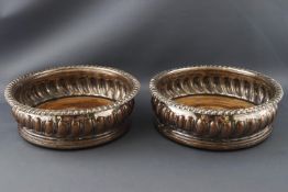 A pair of Sheffield plated decanter coasters with gadrooned edges