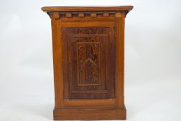 A pine lectern of traditional form with sloping rectangular top over panelled sides set with panels