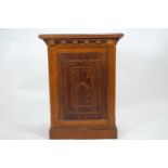 A pine lectern of traditional form with sloping rectangular top over panelled sides set with panels