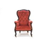 A Victorian carved mahogany lady's armchair with scrolled back with deep buttoned upholstery,