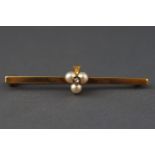 A yellow metal bar brooch having a central trefoil of cultured pearls ....