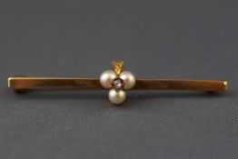 A yellow metal bar brooch having a central trefoil of cultured pearls ....