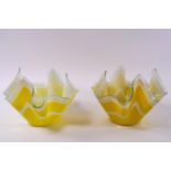 Two glass handkerchief bowls, decorated with white stripes on a yellow ground,