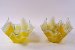 Two glass handkerchief bowls, decorated with white stripes on a yellow ground,