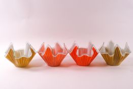 Four glass handkerchief bowls, decorated with white strips, two on yellow grounds,