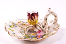 A 19th century floral decorated chamber stick in the form of a scallop shell with loop handle,