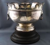 A Monteith style punch bowl with typical style decorative lobed lip over two lion masks ....