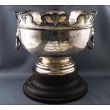 A Monteith style punch bowl with typical style decorative lobed lip over two lion masks ....