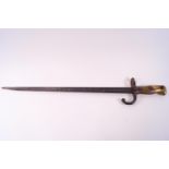 A French bayonet, the steel blade of T section, set to a wood and brass capped handle,