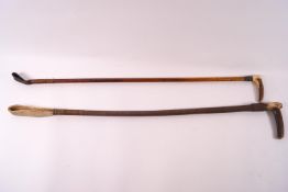 Two ladies riding crops, each with horn handles, the smaller with applied Swaine and Co button,