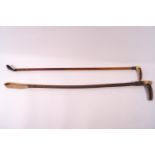 Two ladies riding crops, each with horn handles, the smaller with applied Swaine and Co button,